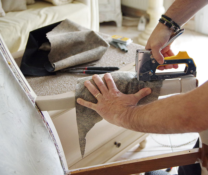 man repairing chair